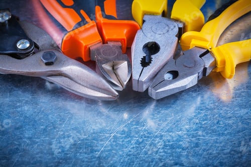 Preview: Close Up View Of Tin Snips Gripping Tongs Nippers On Scratched Vintage Metallic Surface