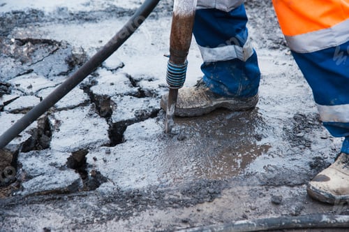 Preview: Road Worker Removes Old Asphalt With A Jackhammer During Road Construction