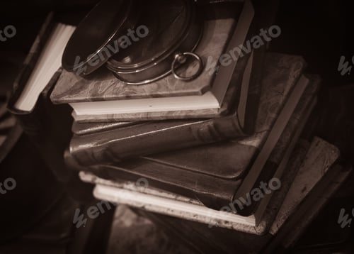 Preview: Compass Lying On A Vintage Books