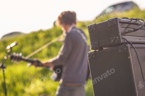 Preview: Detail Of A Rock Band'S Amplifiers With Musicians Playing In The Background In Blurred Live Shows