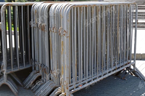 Preview: Many Old Movable Metal Fences Stacked On Public Square