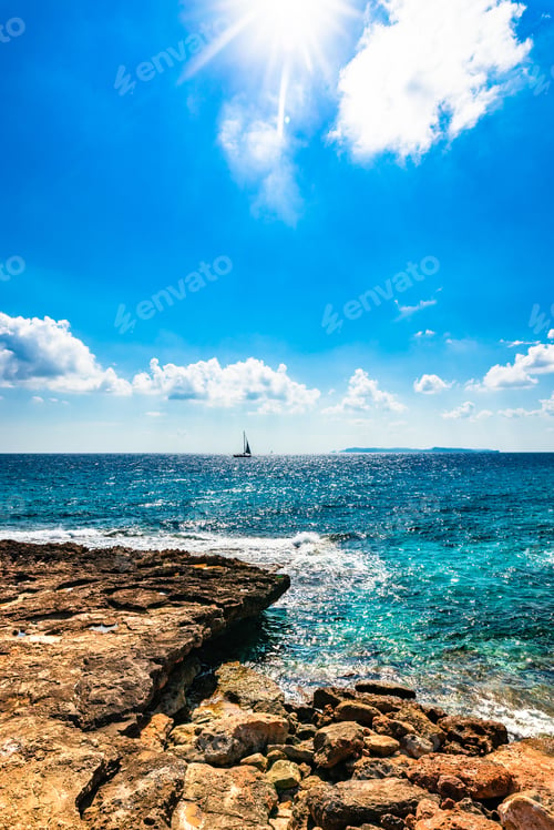 Preview: Beautiful Seascape View With Sailing Boat At The Horizon And Blue Cloudy Sky With Bright Sunrays.