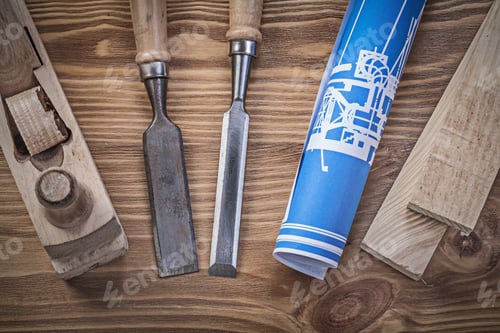 Preview: Blue Rolled Up Construction Drawing Planer Chisels Wooden Studs On Wood Board.