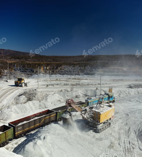 Preview: Excavator Loads Crushed Stone Into Freight Railway Wagons In A Quarry, Vertical Panorama.