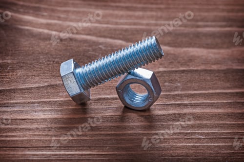 Preview: Metal Bolt And Nut On Wooden Board Construction Concept