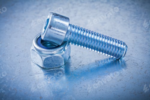 Preview: Stainless Screw Nut And Bolt Detail On Flat Metallic Background Construction Concept.