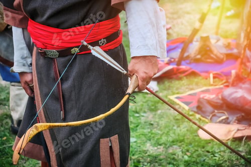 Preview: Archer In National Dress With A Bow And Arrow In His Hands. Hunter Tribes On The Warm Summer Day.
