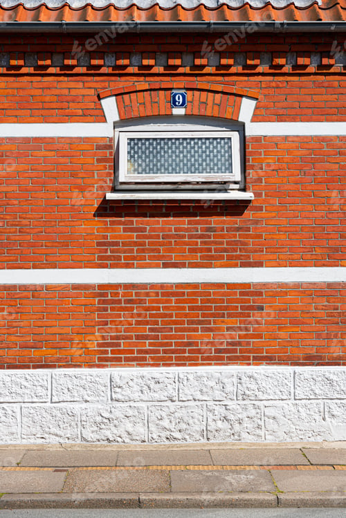 Preview: The Number Nine, 9, Above A Small Window On A Red Brick House.