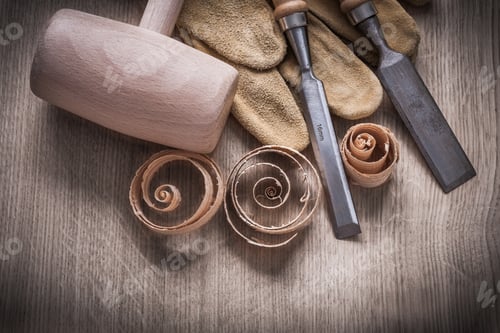Preview: Wooden Mallet Curled Up Shavings Firmer Chisels Leather Gloves On Wood Board Construction Concept.