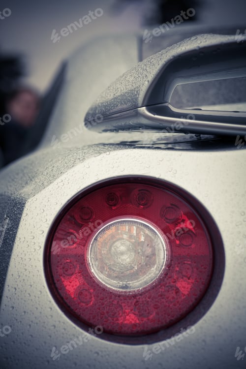 Preview: Detail On The Rear Light Of A Car On A Rainy Day.