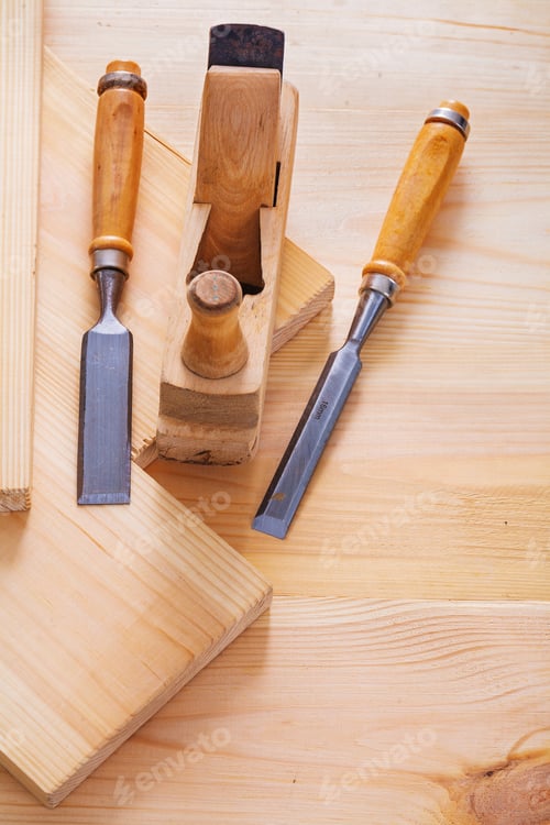 Preview: Old Fashioned Woodworkers Plane And Joinery Chisels On Wooden Boards
