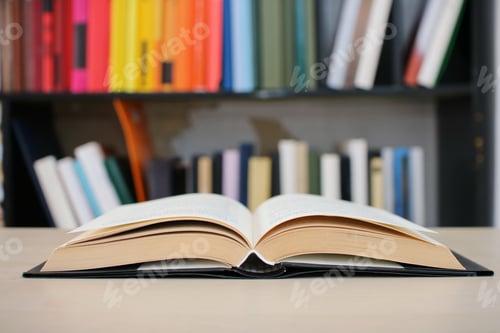 Preview: An Open Book On A Desk In The Library