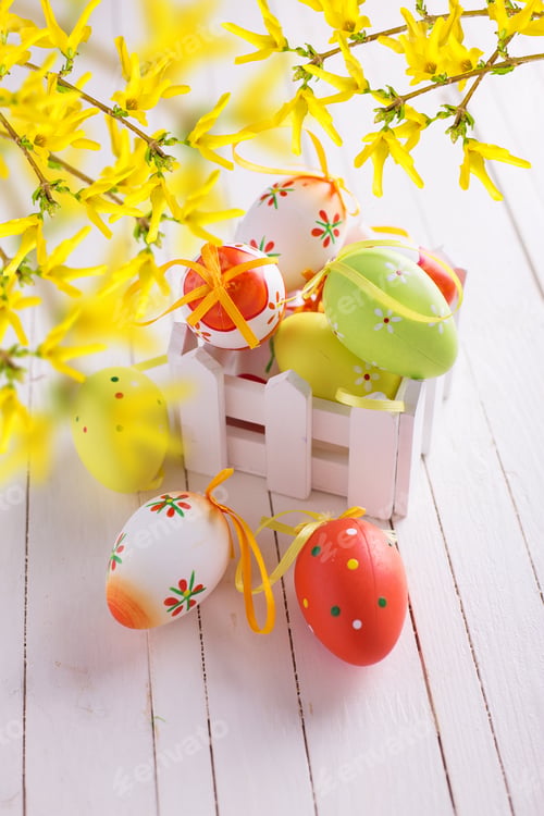 Preview: Colorful Easter Eggs In Box On White Painted Wooden Planks. Easter Background.
