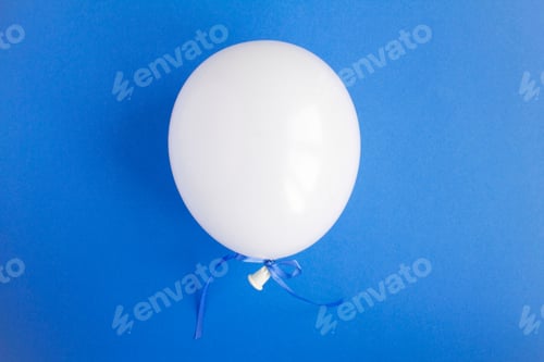 Preview: One White Balloon In The Center Of The Blue Background. Top View. Copy Space.