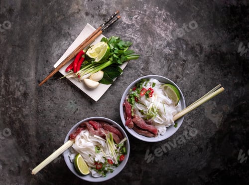Preview: Traditional Vietnamese Soup Pho Bo Served On The Rustic Metal Background Decorated With Bamboo Chop