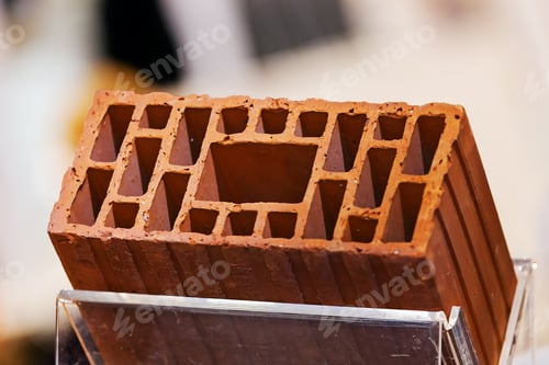 Preview: Detail Of Orange Hollow Clay Block On A Stand At Construction Fair