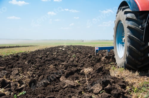 Preview: Close-Up Of The Rear End Of A Tractor While Plowing