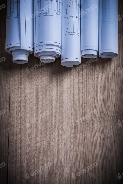 Preview: Vertical Image Of Construction Drawings On Wooden Board.