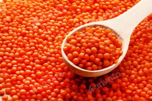 Preview: Orange Lentils In A Wooden Spoon On A Background Of Lentils