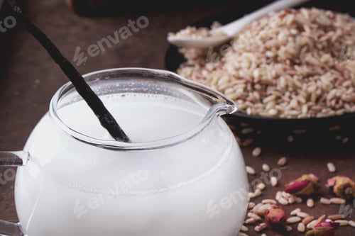 Preview: A Glass Of Home Made Rice Milk Served With Brown Rice, Honey And Organic Sugar Candies On A Rustic