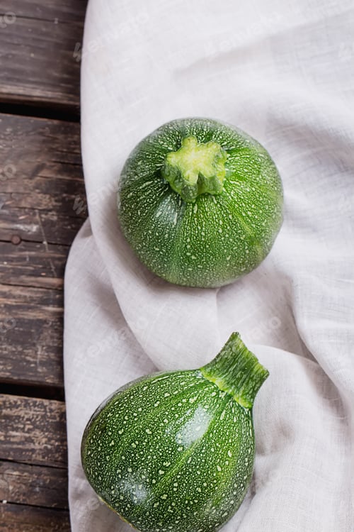 Preview: Mini Zucchinis On Rustic Wooden Board With Napkin And Knife. Top View