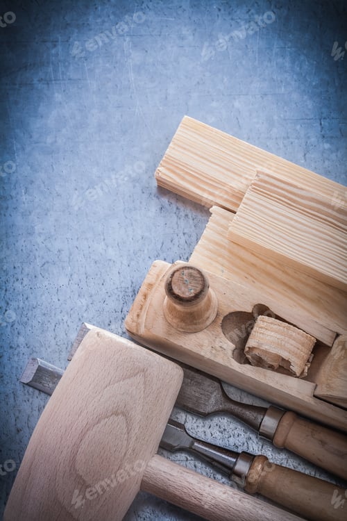 Preview: Wooden Planer Hammer Bricks Flat Chisels On Metallic Background.