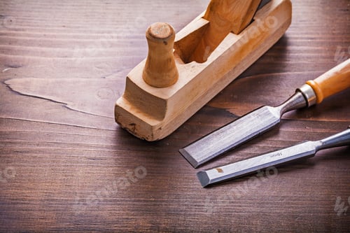 Preview: Classic Wooden Woodworkers Plane And Carpentry Chisel On Vintage Board Construction Concept