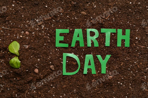 Preview: Plant And Text Earth Day On Soil