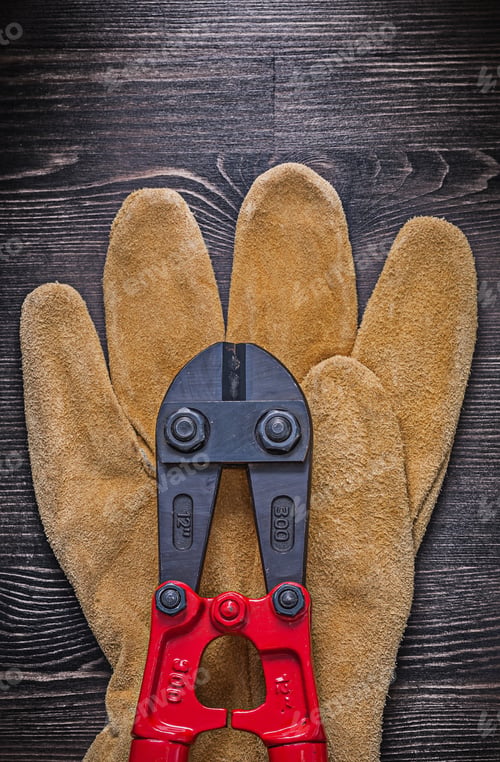 Preview: Leather Safety Glove Steel Cutter On Wooden Board Construction Concept.