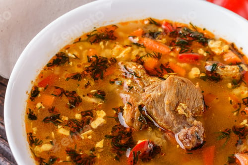 Preview: Georgian Soup. Kharcho With Rice, Tomato, Beef, Garlic And Herbs In Bowl On Wooden Table