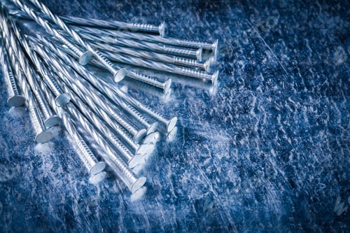 Preview: Stainless Construction Nails On Scratched Metallic Background Close Up View Building Concept.