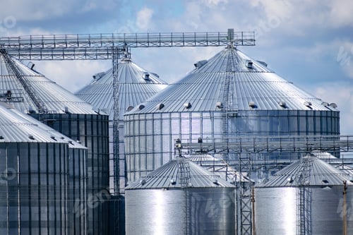 Preview: Grain Elevator Silos Closeup With Cloudy Sky On The Background
