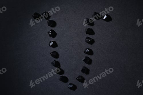 Preview: Symbol Of The Zodiac Sign Aries Made By Black Stones On A Black Background. Low Dark Key