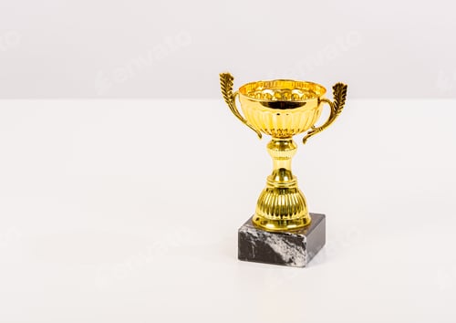Preview: Gold Trophy With Marble Base On Light Grey Background.