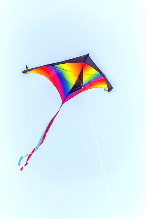 Preview: Colorful Kite Flying On Sky Background. Retro Style, Toned Photo.