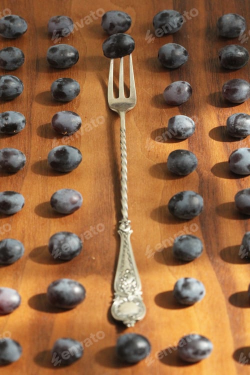 Preview: Grapes. Conceptual Design. The Grapes Are Arranged In Rows Around The Vintage Fork, On A Wooden