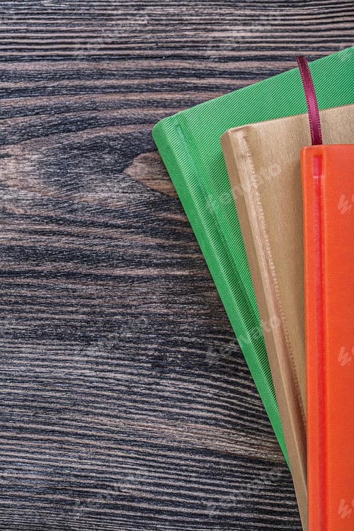 Preview: Pocket-Books On Vintage Wooden Board Education Concept.