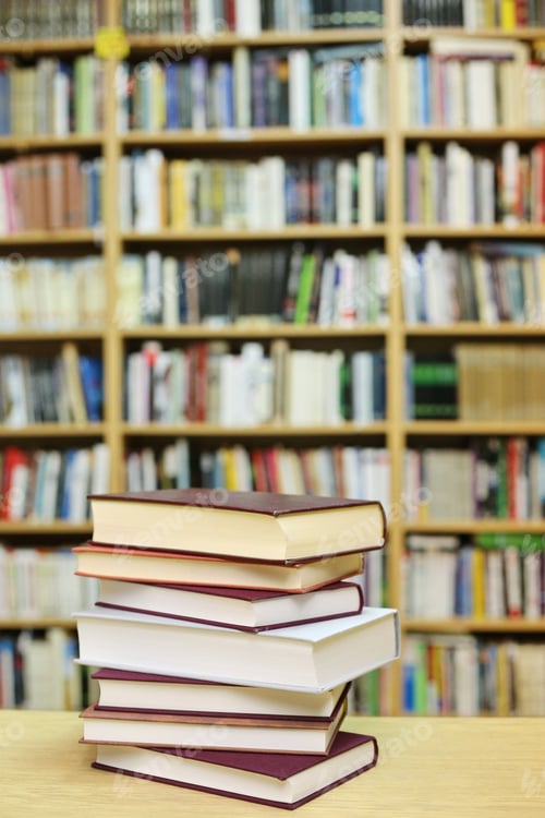 Preview: Stacked Books On A Desk In The Library