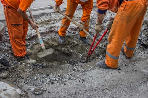 Preview: Workers Work On The Replacement Of Cover Slab With Cast Iron Cover On The Road With The Help Of A