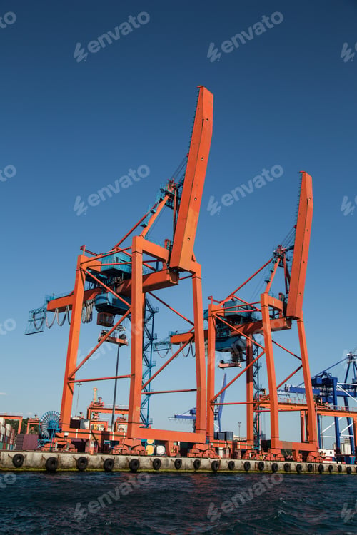 Vista previa: Orange Port Cranes In A Sea Port