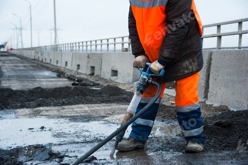 Preview: Road Worker Removes Old Asphalt With A Jackhammer During Road Construction