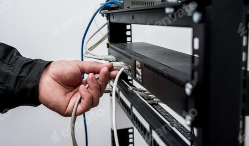 Preview: Technician Connecting Network Cables To Switches. Connecting Cables In Server Cabinet. Background