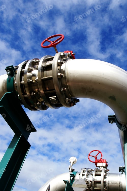Preview: Industrial Zone, Steel Pipelines And Valves Against Blue Sky