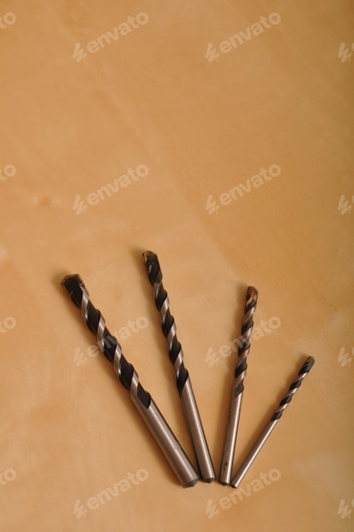 Preview: Set Of Drill Bits On Wooden Background (Shallow Depth Of Field)