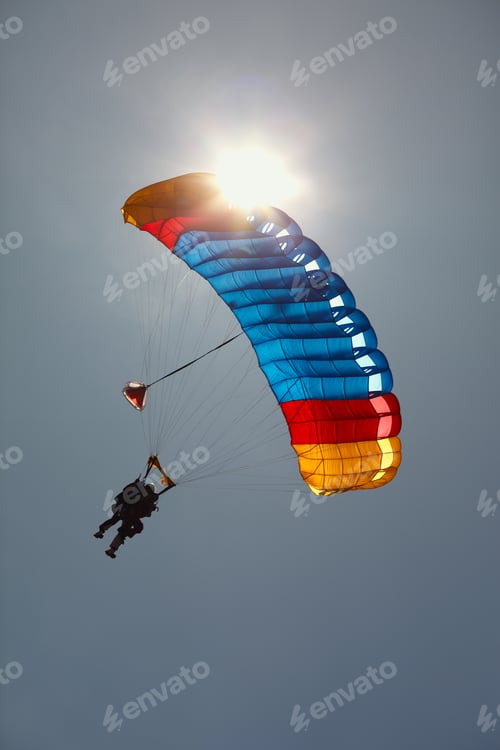 Preview: Bright Dome Of A Parachute With A Tandem Against The Background Of The Sun And A Cloudless Sky