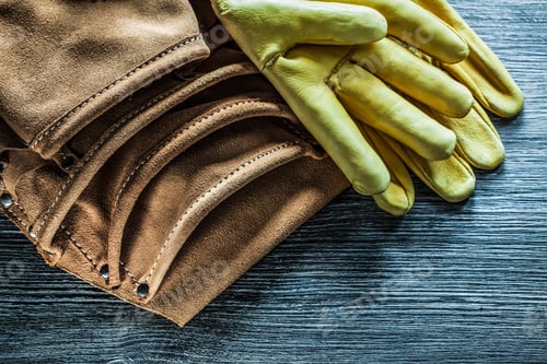 Preview: Leather Tool Belt Safety Gloves On Wooden Board.
