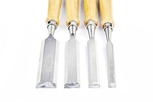 Preview: Four Chisels Of Various Widths Lying On A White Background