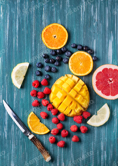 Preview: Slices Of Fresh Fruits Over Metal Blue Background. Top View