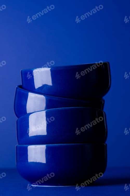 Preview: Stack Of Blue Bowls Over Dark Blue Background