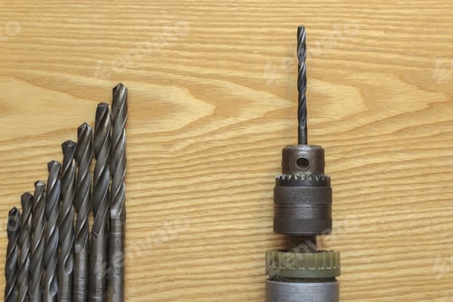 Preview: The Old Drill And Drill Bits On Wooden Background